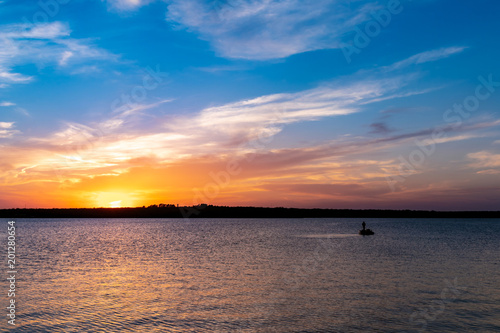 Fishing on the lake at sunset.