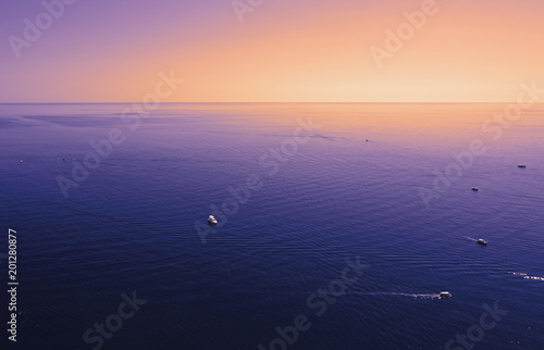 Violet yellow orange purple Black sea surface isolated with boats, yachts.  © Olga