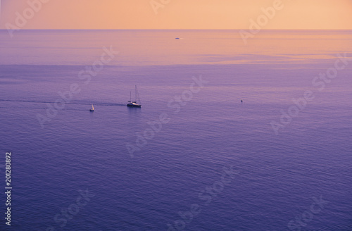 Violet yellow orange purple Black sea surface isolated with boats, yachts. 