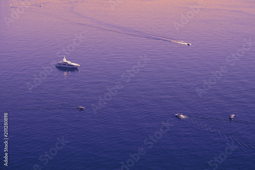 Violet yellow orange purple Black sea surface isolated with boats, yachts.  © Olga