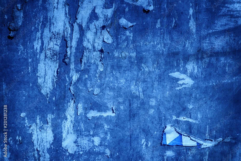Ultra blue Torn poster after vote on tin textured wall. Ripped newspaper