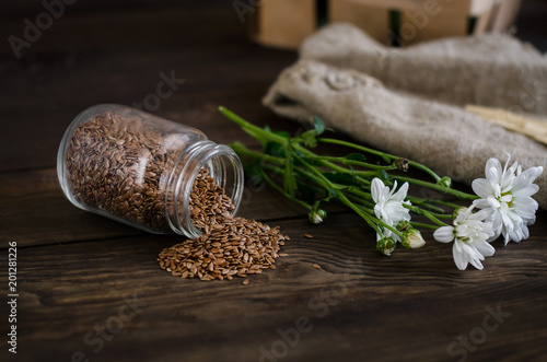 Flax seeds on a dark wooden background