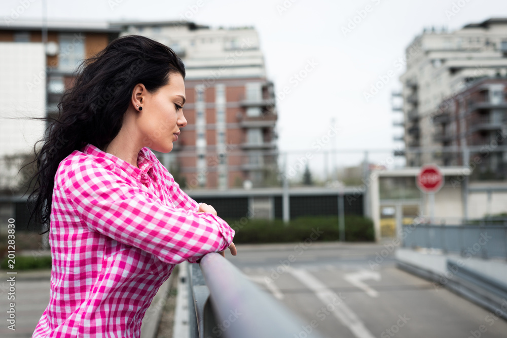 A view of a young and beautiful girl. A pretty woman is staring at the street, she is looking ahead. Sensual female look. Portrait of a smiling and fashionable girl. A view of a young and beautiful girl. A pretty woman is staring at the street, she is looking ahead. Sensual female look. Portrait of a smiling and fashionable girl.
