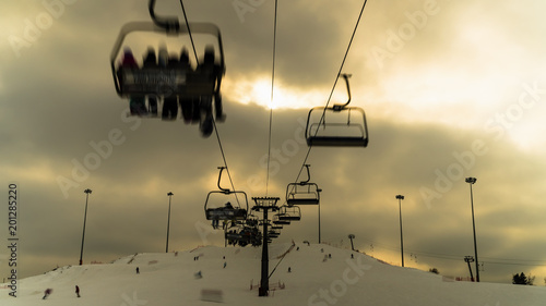 skiers and snowboarders on the ski lift