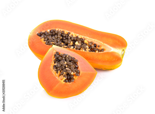 cut ripe papaya with seeds on white background