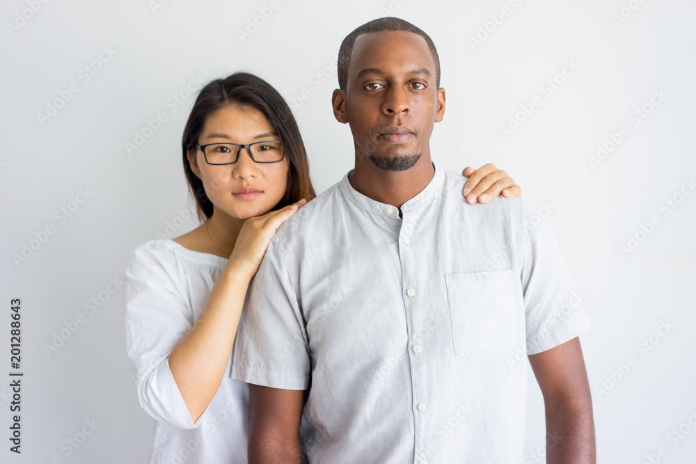 Calm Beautiful Young Interracial Couple Looking At Camera Serious Asian Girl Supporting 
