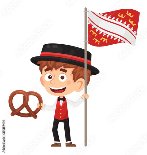 Petit garçon alsacien tenant le drapeau alsacien et un bretzel