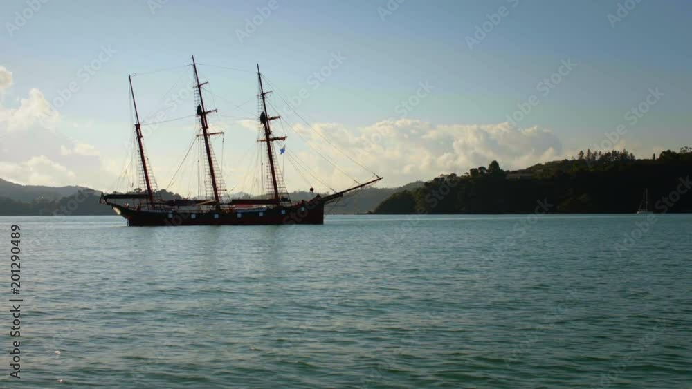 Ship with three masts floating beside coast Ship with three masts floating beside coast