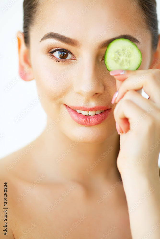 Skin Care. Happy Sexy Woman Posing With Slices of Cucumber in Her Hands on White Background. Beauty Treatment. Cosmetology. Beauty Spa Salon. Home spa Skin Care. Happy Sexy Woman Posing With Slices of Cucumber in Her Hands on White Background. Beauty Treatment. Cosmetology. Beauty Spa Salon. Home spa
