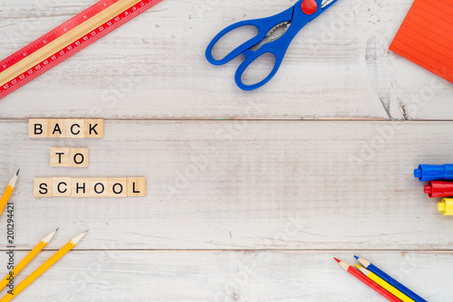 Assorted school supplies on a wood plank table