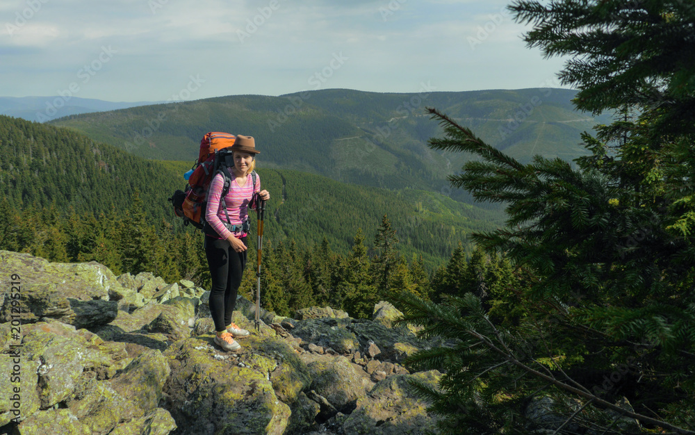 Obraz premium female hiker walking on a trail on highlands, jeseniky mountains, czech republic