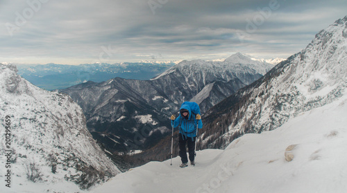 female hiker walking in a beautiful winter alpine landscape