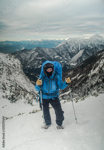 female hiker walking in a beautiful winter alpine landscape