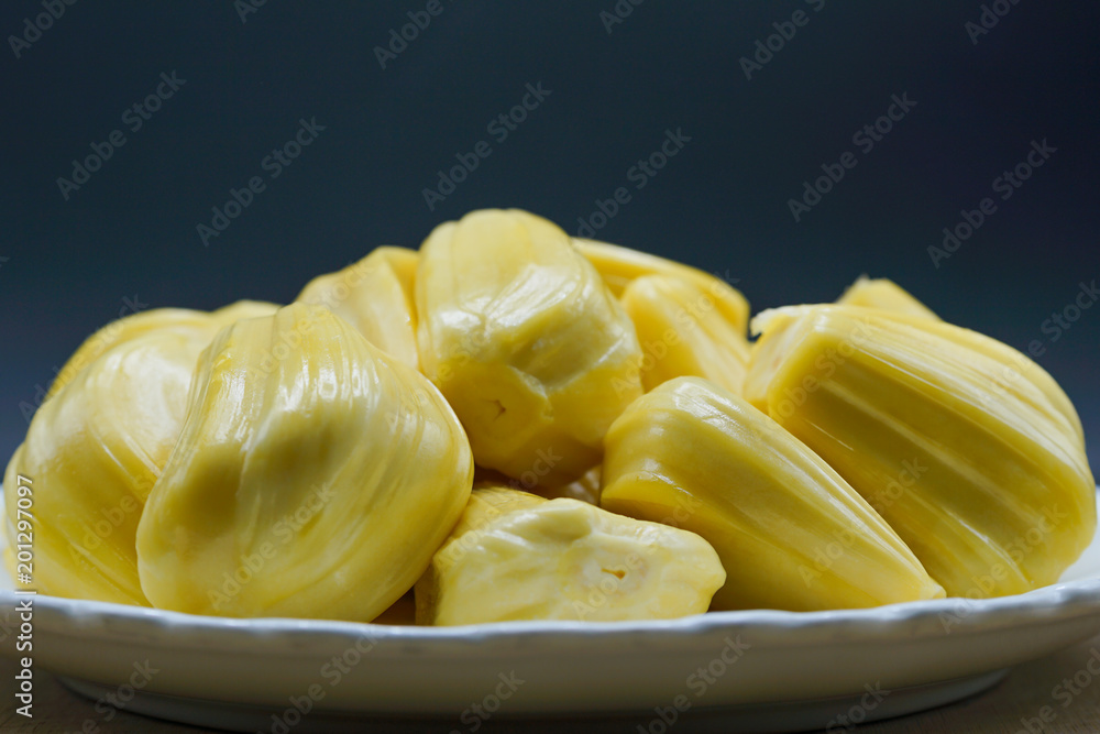 Fresh jackfruit slices on a white plate. sweet yellow jackfruit ripe. vegetarian, vegan, raw food. Exotic tropical fruit - closeup isolated Fresh jackfruit slices on a white plate. sweet yellow jackfruit ripe. vegetarian, vegan, raw food. Exotic tropical fruit - closeup isolated