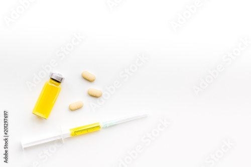 Medical therapy. Syringe, bottle with drug, pills on white background top view copy space