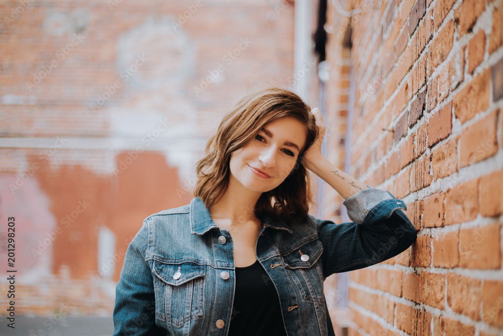 Cute Attractive Young Woman Modeling on Brick Wall