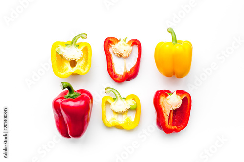 Layout of red and yellow sweet bell pepper slices on white background top view pattern