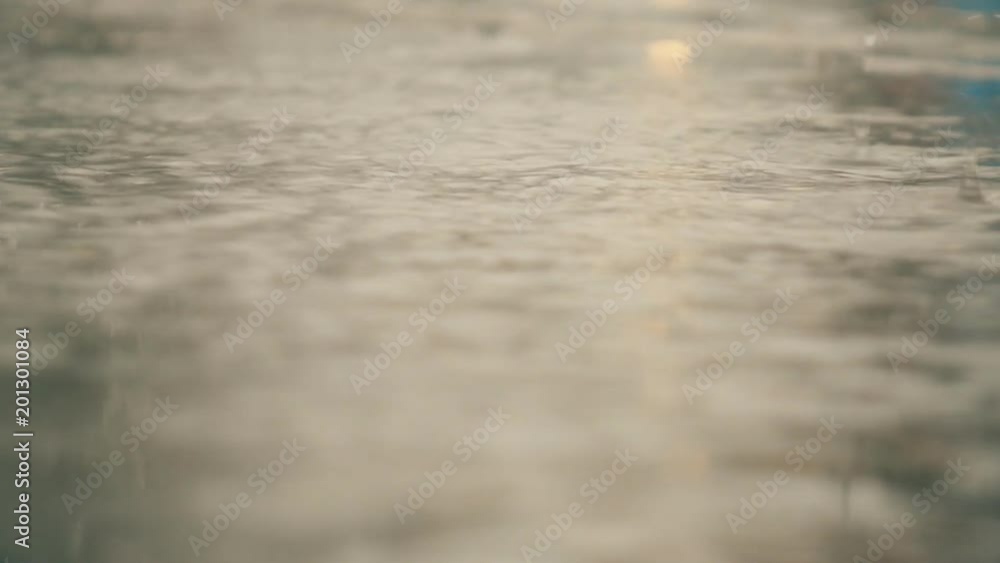 Slow Motion. Raindrops falling on a puddle. Rainy day. Slow Motion. Raindrops falling on a puddle. Rainy day.