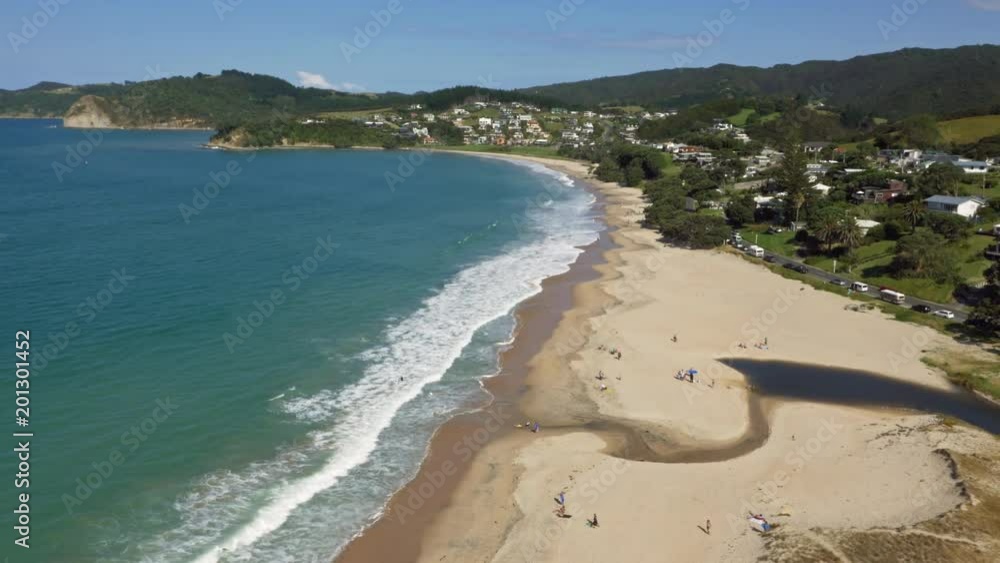 Drone shot pan up people sunbathing on Northland beach, New Zealand Drone shot pan up people sunbathing on Northland beach, New Zealand