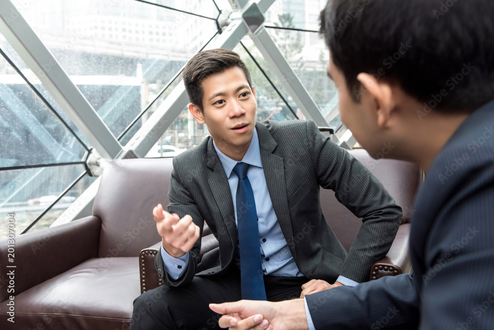 Asian Chinese businessman talking with his partner Asian Chinese businessman talking with his partner