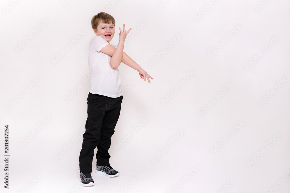 cute boy aged 6 years shows on a white background in different poses different emotions cute boy aged 6 years shows on a white background in different poses different emotions