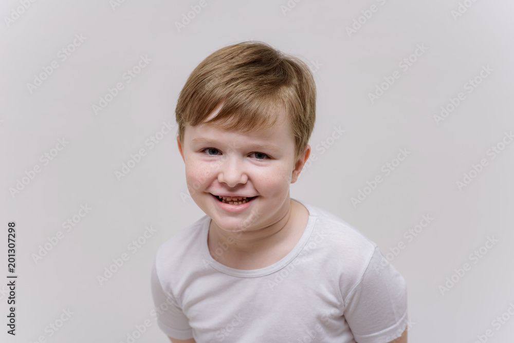 cute boy aged 6 years shows on a white background in different poses different emotions cute boy aged 6 years shows on a white background in different poses different emotions