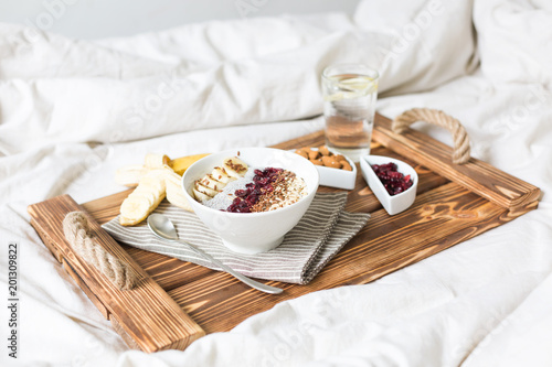 Chia pudding with nuts and fruits. Breakfast in bed on a tray. View from above.