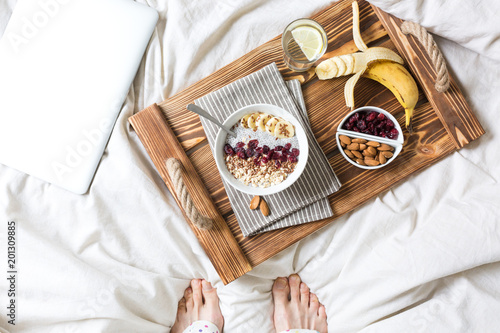 Chia pudding with nuts and fruits. Breakfast in bed on a tray. View from above.