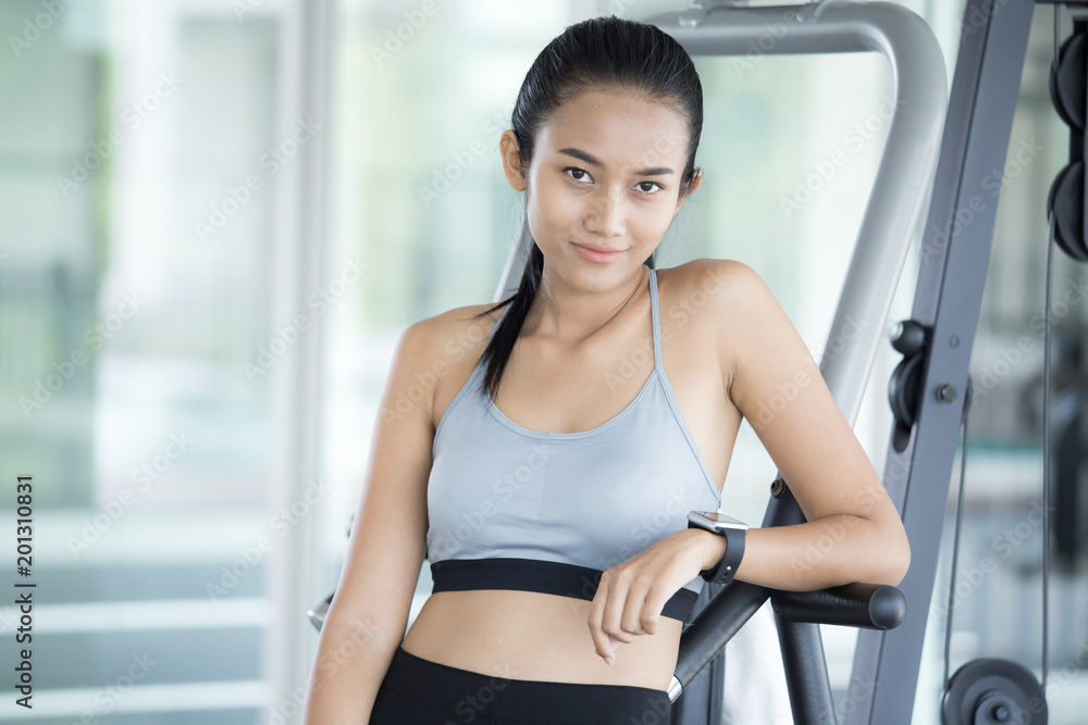 Asian beautiful woman using smartwacth at gym. Sport and Reaction concept.