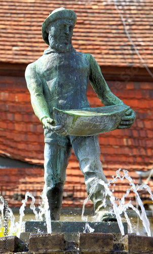 Darlowo, Poland - Historic quarter with famous Fountain - Fisherman Memorial at the market square photo