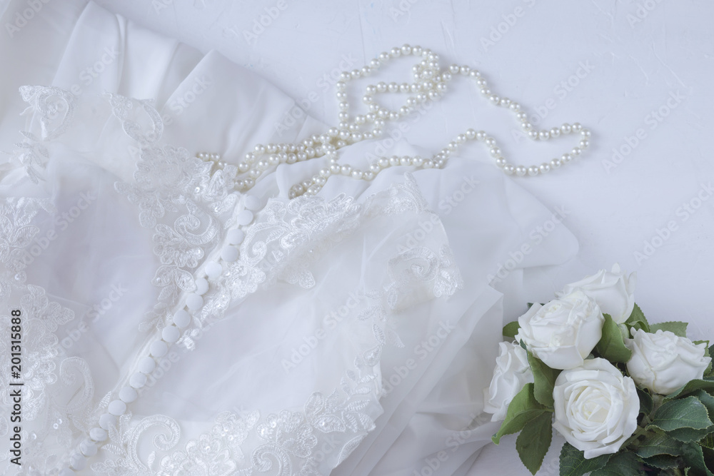 Preparing the bride for the wedding: dress, pearls, roses - wedding background Preparing the bride for the wedding: dress, pearls, roses - wedding background