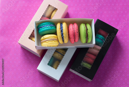 mix of macaroons in colored boxes