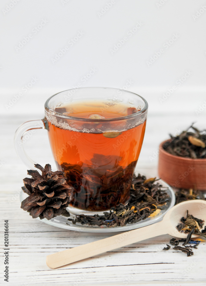 Cup of tea with tea leaves scattered. Cup of tea with tea leaves scattered.