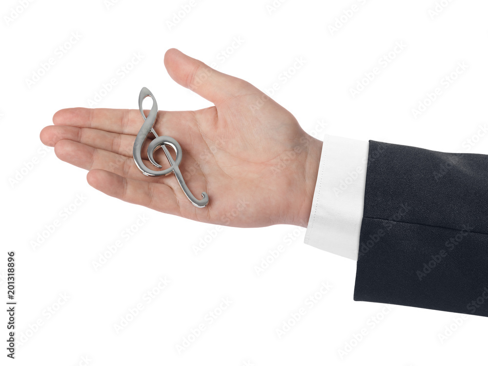 Hand holding a treble clef