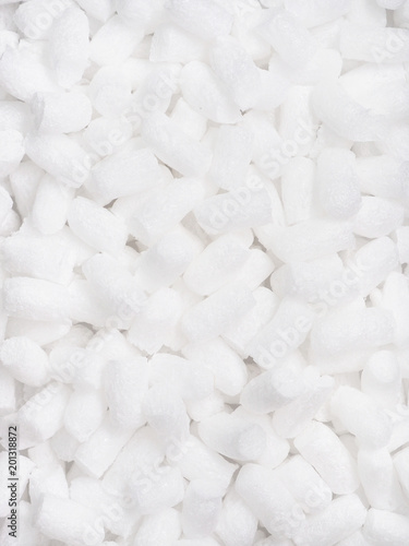 Vertical filler packing background. Packaging foam pellets texture, top view, close-up. Polystyrene, white styrofoam packing peanuts used to prevent damage to fragile objects during shipping