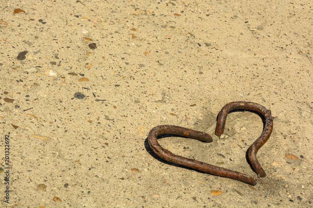 metal heart and copyspace on a concrete surface metal heart and copyspace on a concrete surface