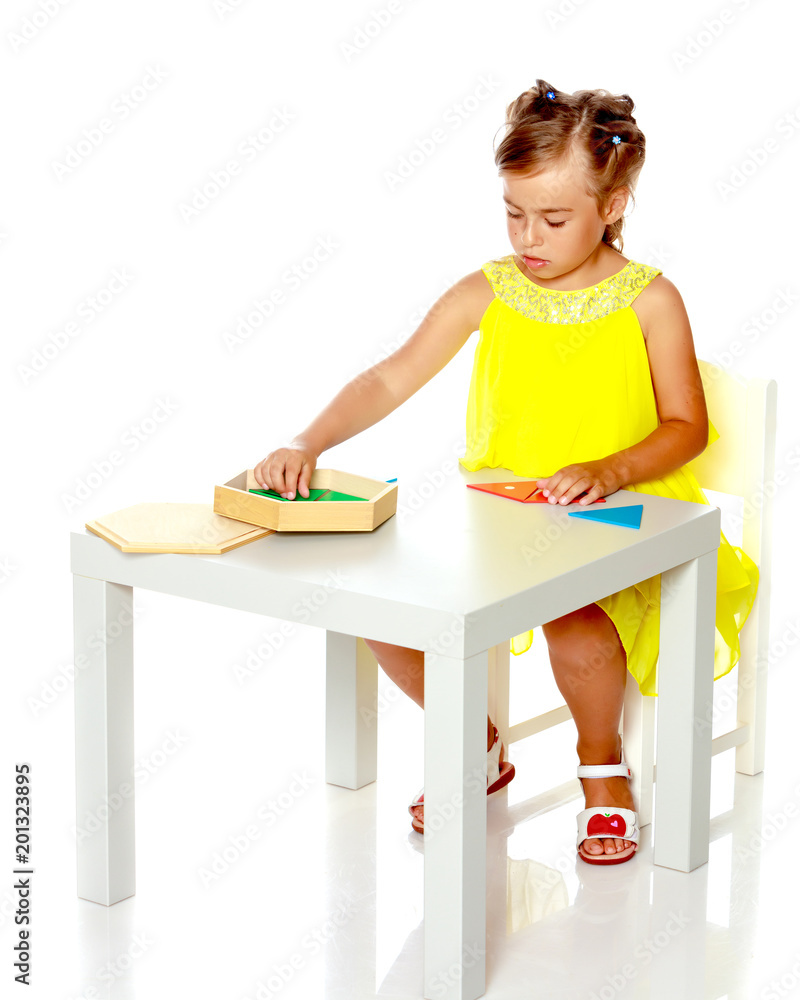 A little girl is studying Montessori stuff. A little girl is studying Montessori stuff.