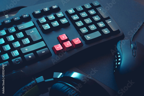 gaming keyboard, headphones and mouse on black table