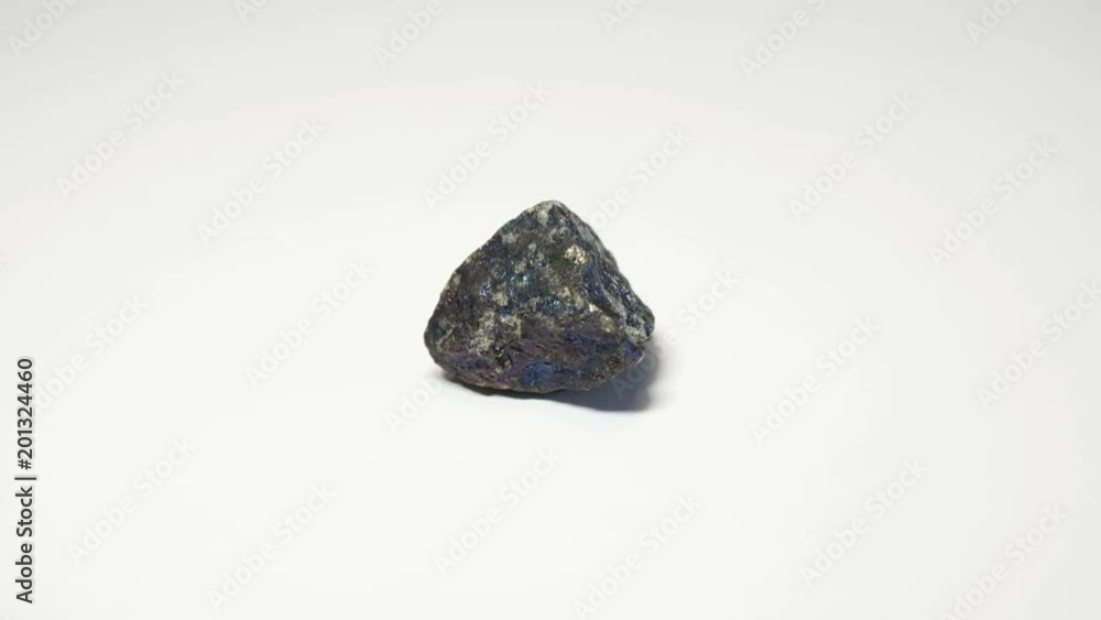 Macro shot of bornite mineral isolated over white background and spinning around
Macro shot of bornite mineral isolated over white background and spinning around