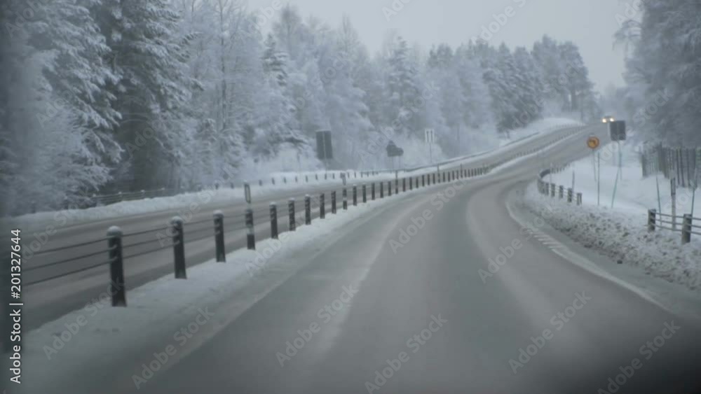 Man driving a car through the winter road Man driving a car through the winter road