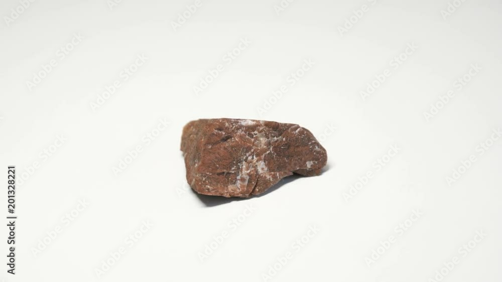 Macro shot of jasper mineral isolated over white background and spinning around
Macro shot of jasper mineral isolated over white background and spinning around