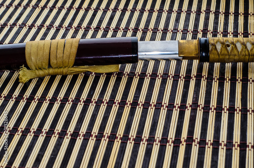 Japanese sword katana on bamboo mat