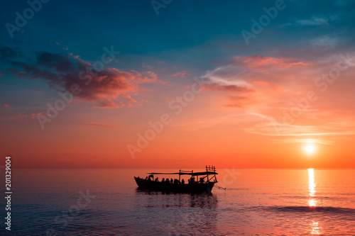 Beautiful Sunset at Sunset Beach with ship with tourist on the board in the background. Koh Rong Samloem, Cambodia. 