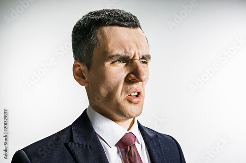 Bilde på lerret Three-quarter portrait of a businessman with disgust face