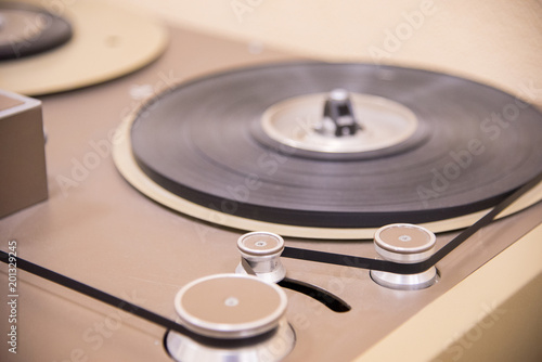 Part of the old vintage tape recorder is brown with cassettes