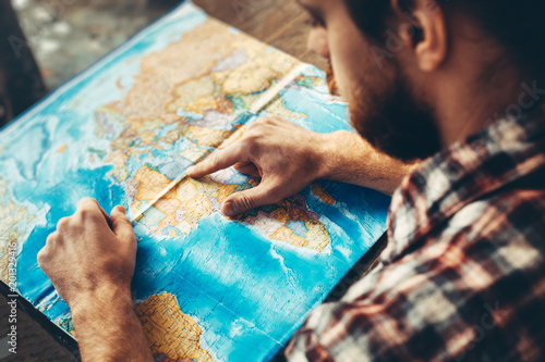 Young Hiking Man With Beard Is Planning Journey Travel With Map.