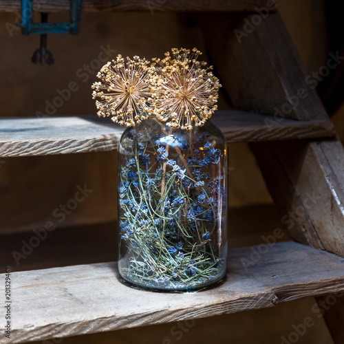 A decorative jar with dry flowers