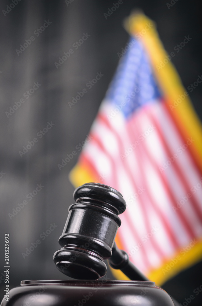Judge Gavel and United States of America flag on a black wooden background. Judge Gavel and United States of America flag on a black wooden background.