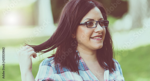 Portrait of beautiful young woman in parkr, light effect photo