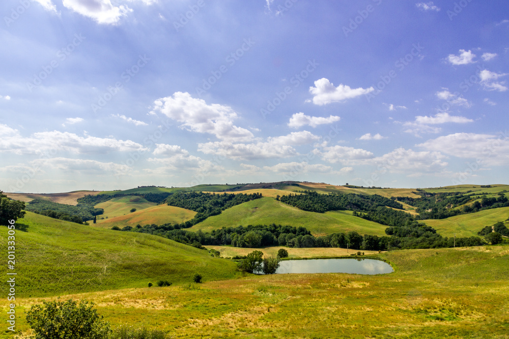 Typical Tuscan Landscape, Gentle Hills, Small Lake Under A Summer Sky
